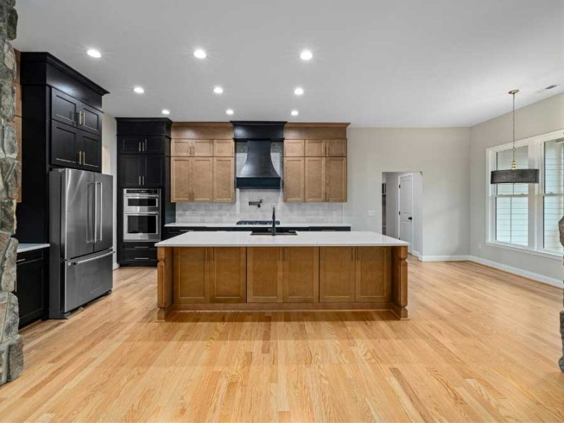 Make Ready Home fall kitchen update ideas in a spacious two-tone kitchen with wood cabinetry, large island, and natural light.